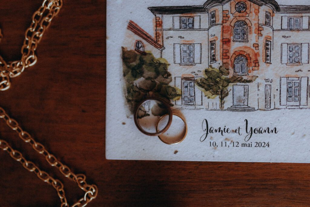 Faire-part illustré du Domaine de Tourieux avec alliances, mariage de Jamie et Yoann